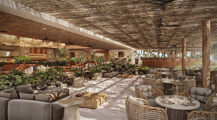 Spacious open-air restaurant with woven ceiling, ceiling fans, modern cushioned seating, round tables, and abundant greenery. Natural light streams in, creating a relaxed, tropical atmosphere.