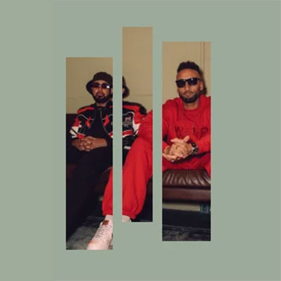 Two men sit on a couch, both wearing sunglasses and athletic outfits, one in black and red, the other in all red. The image is divided into three vertical bars on a light gray background.