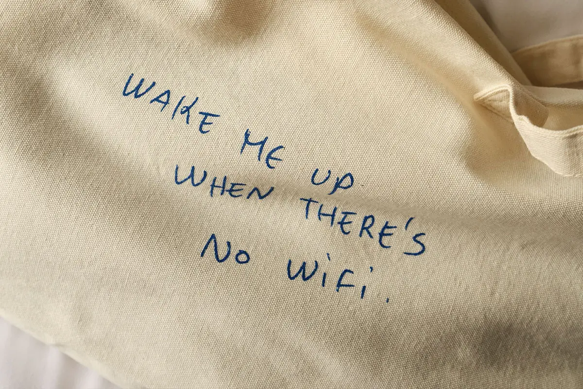 A beige fabric with blue handwritten text that reads, 