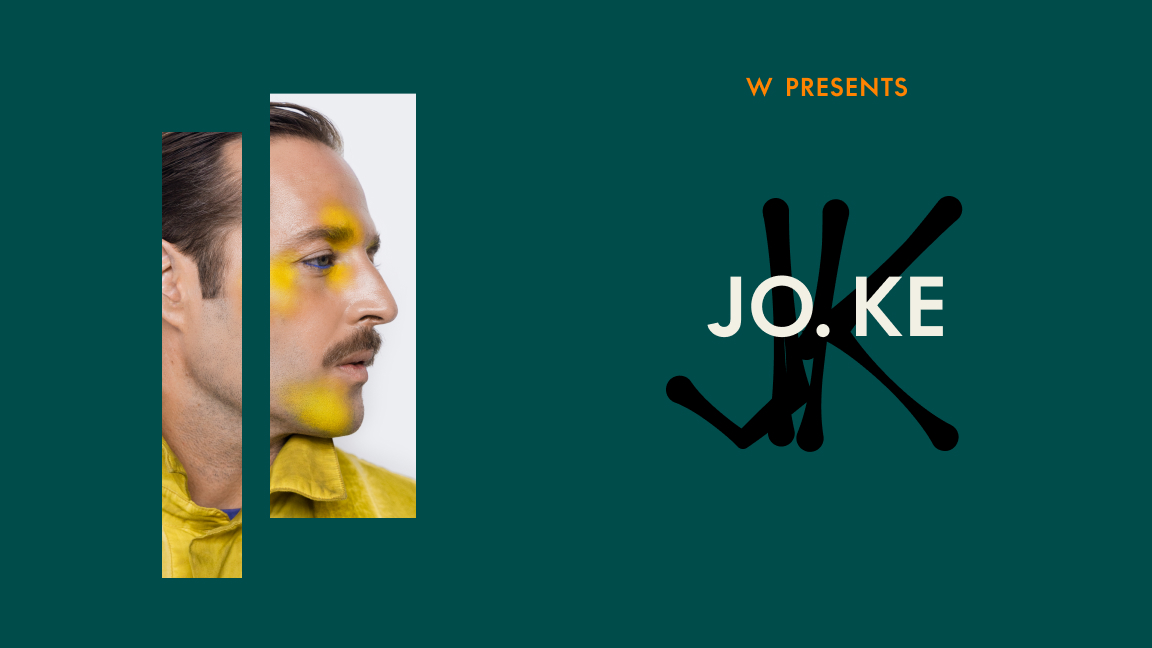 A man with yellow face paint and a mustache is shown in profile within two vertical rectangles on a green background. The text reads